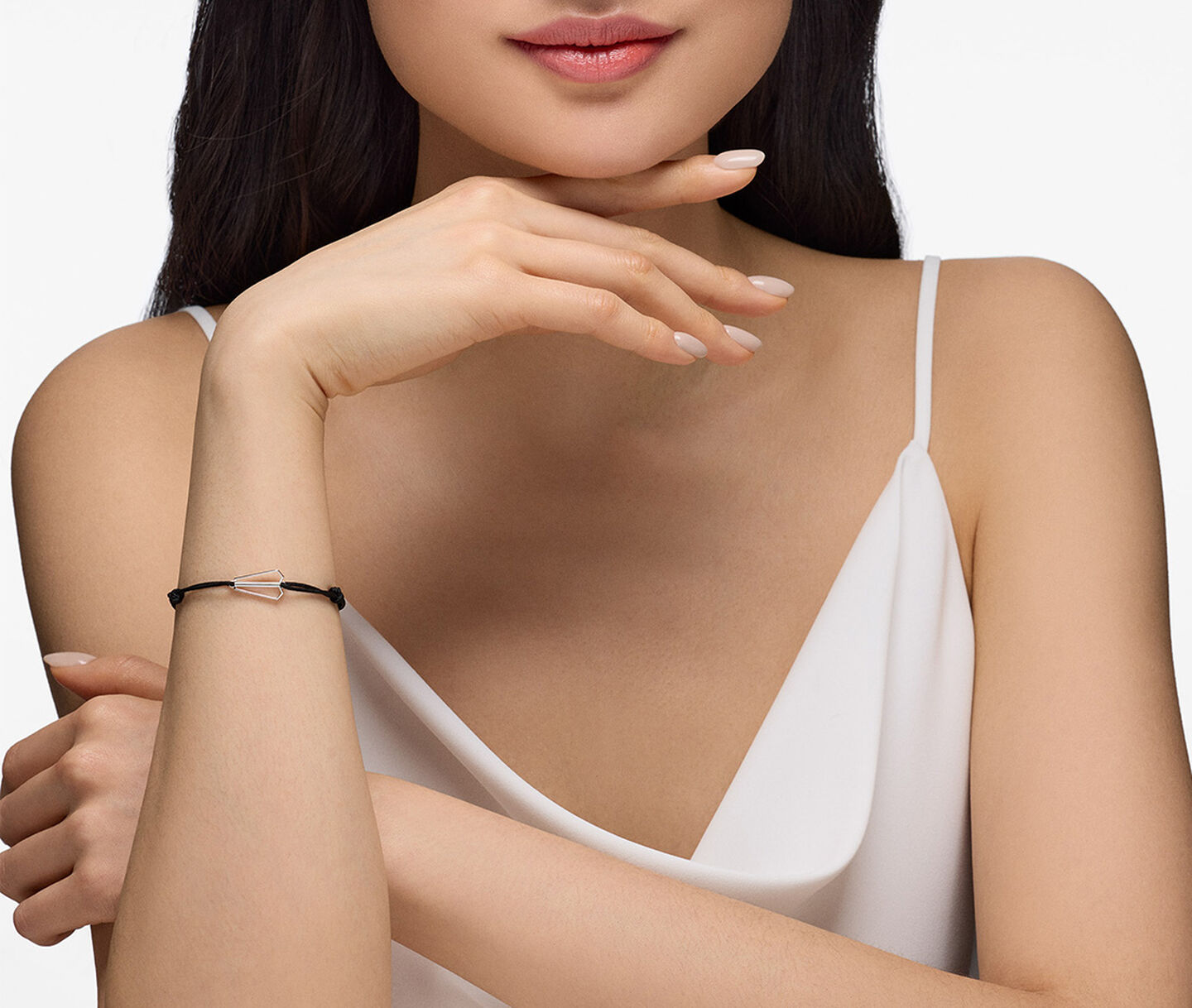 A woman wearing a Birks Beekeeper cord and silver bracelet.